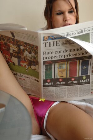 Chubby cutie with big natural boobs reads newspaper flashing pink panties