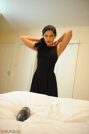 Glamorous brunette takes off black dress and red lingerie posing naked on the bed