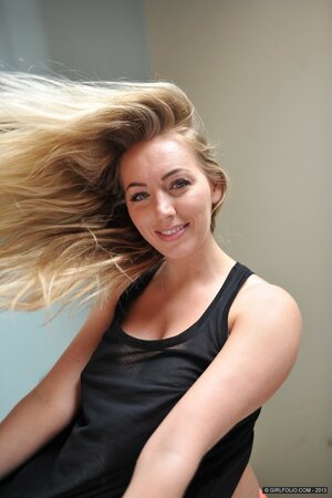 Awesome nympho flaunts her big breasts and round booty by the window