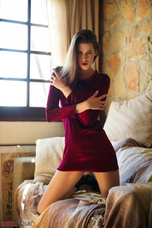Good-looking brunette teen is not shy to slowly undress and pose naked