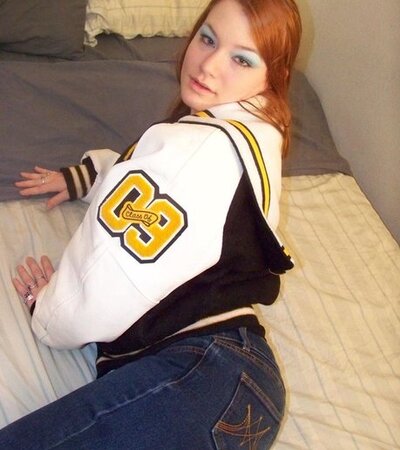 Red-haired teen whore exposes her immense natural breasts and shaved twat