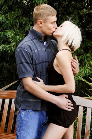 Lovely blonde lassie and her lover casually undress till bare nudity outdoors
