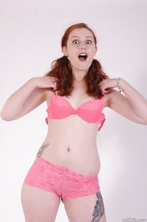 Dazzling redhead in knee socks can’t resist undressing and exposing her sexy body
