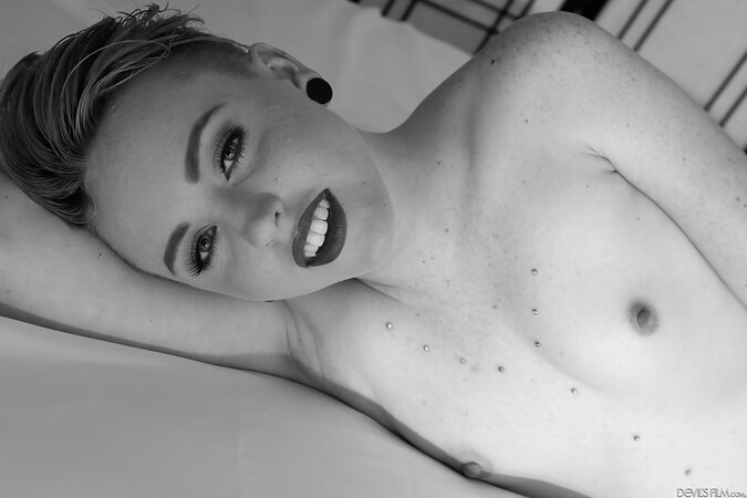 Short-haired slut with sexy piercing lies naked and spreads pussy for the cam
