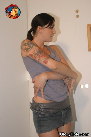 Tall inked brunette gives pleasant glory-hole blowjob to the black dude