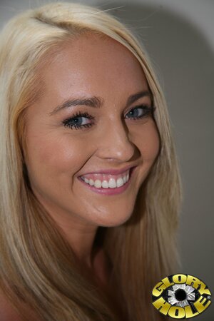 Blond hussy Ashley Stone handles two black cocks in a gloryhole room at once