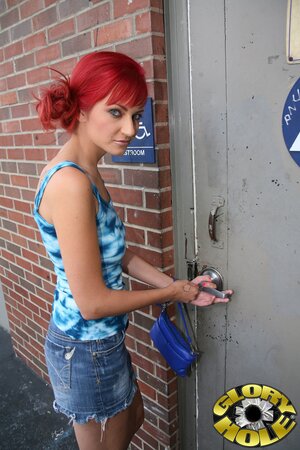 Playful redhead with pierced nipples gets analyzed in the bathroom with gloryhole