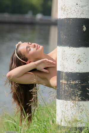 Glamorous teenage girl exposes her slender body when walking in the nude