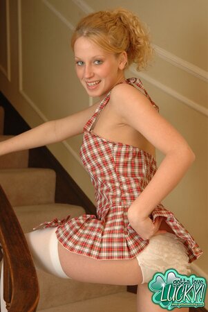 Blonde in stockings slowly takes off short dress to tease with her slim body