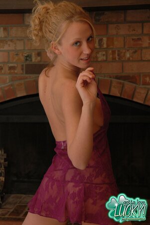 Babe in sexy lingerie and thong poses for erotic photo-shoot by the fire-place