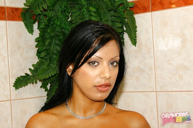 Lovely black-haired minx gently touches round butt while taking hot shower