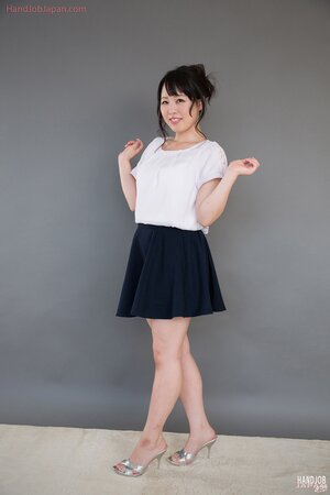 Shy Japanese colleen massages stiff pecker and licks sperm from fingers