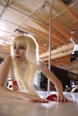 Playful blond MILF in stockings shows off her stripping skills on the stage