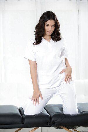 Horny masseuse undresses till bare nudity waiting for her favorite client