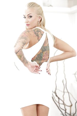 Blonde whore with big fake tits and tattoos makes men fantasize about her