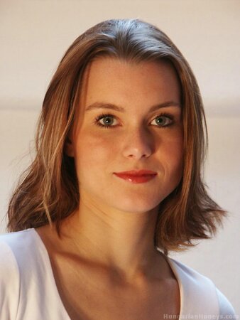 Young European office girl strips and touches her peach at working place