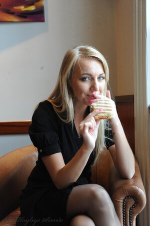 Nerdy-looking blonde gets naughty and hikes up her black dress to show panties