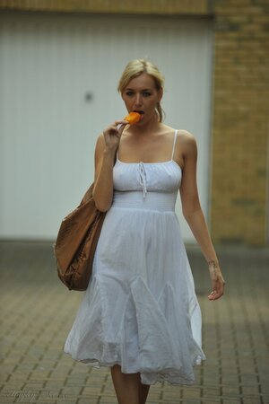 Hot blond beauty eats an ice cream while baring awesome tits after long walk