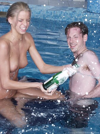 Skinny naked babe playfully teases two horny guys in the pool for the camera