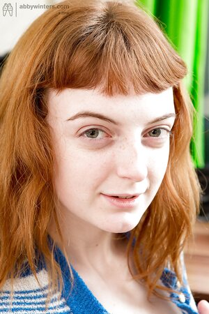 Leggy redheaded hottie fingering her pussy while working