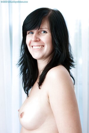 Brunette with jet black hair is going to show her cleavage