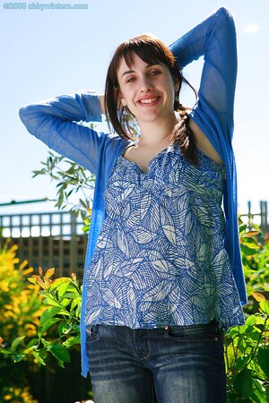 Redheaded babe bends over to showcase her firm booty for you