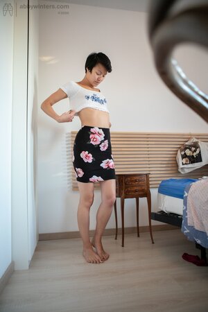 Short hair babe is showing her small boobs and long legs