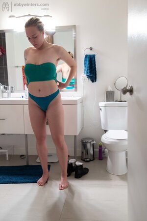 Blonde in a thong shows her backside while changing quickly