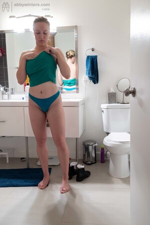 Blonde in a thong shows her backside while changing quickly