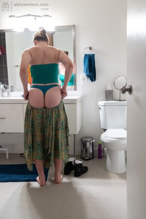 Blonde in a thong shows her backside while changing quickly