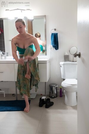 Blonde in a thong shows her backside while changing quickly