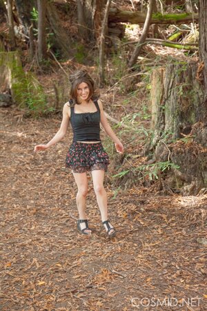 Pretty gal takes off her panties to showcase twat in the woods