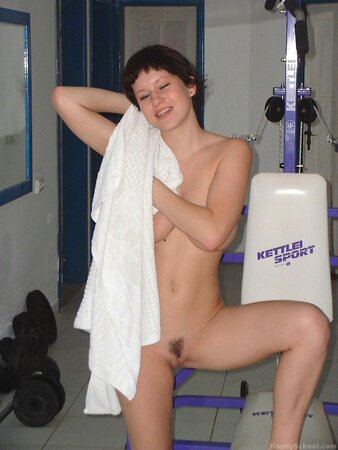 Hottie with short hair working out in the gym before stripping