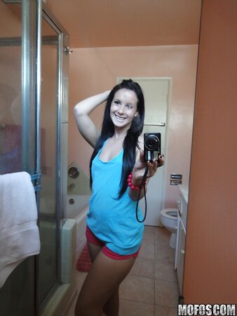 Saucy stunner taking some selfies in the bathroom while stripping