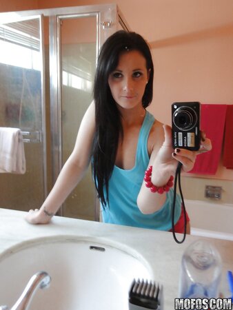 Saucy stunner taking some selfies in the bathroom while stripping