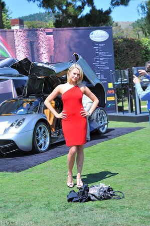 Stunner is posing by the newest cars before going indoors