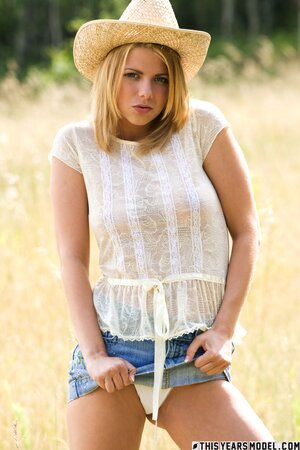 Hot blonde strips down to pose naked not far from her farm