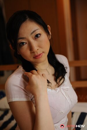 Emiko Koike poses in a white dress and shows off her big ass