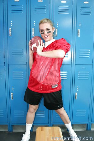 Female football player prepares for game by posing naked in locker room