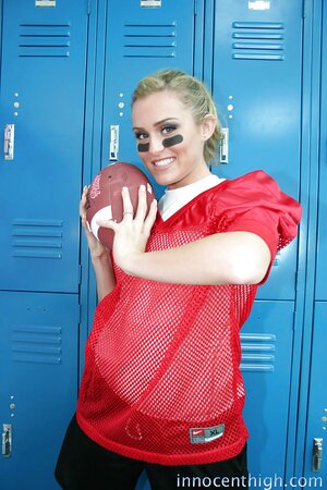 Female football player prepares for game by posing naked in locker room
