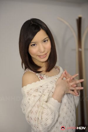 Young Japanese girl poses in short skirt that accentuates her long legs