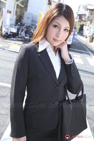 Beautiful Japanese secretary seductively poses while going at her work