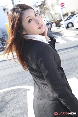 Beautiful Japanese secretary seductively poses while going at her work