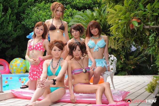 Oriental girlfriends in skimpy bikinis rest half-naked with men poolside