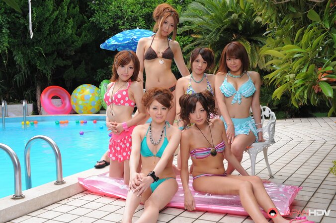 Oriental girlfriends in skimpy bikinis rest half-naked with men poolside