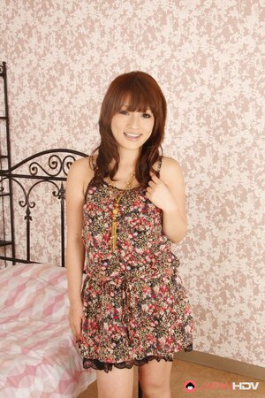 During photo shoot in bedroom Asian beauty provocatively takes clothes off