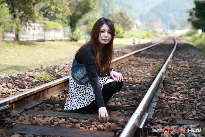 Good-looking oriental lassie walks alone and slowly gets naked on camera