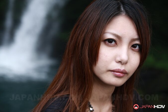 Good-looking oriental lassie walks alone and slowly gets naked on camera