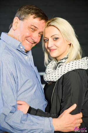 Blonde girl with a fit figure is ready to take on a mature man