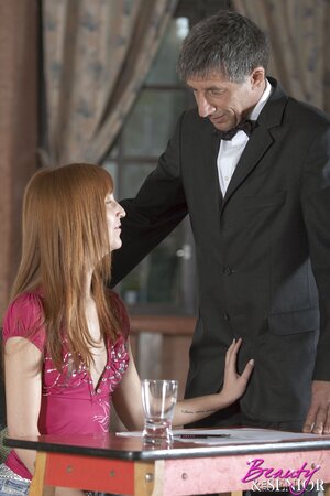 Young redhead takes off her clothes before sex with an older man